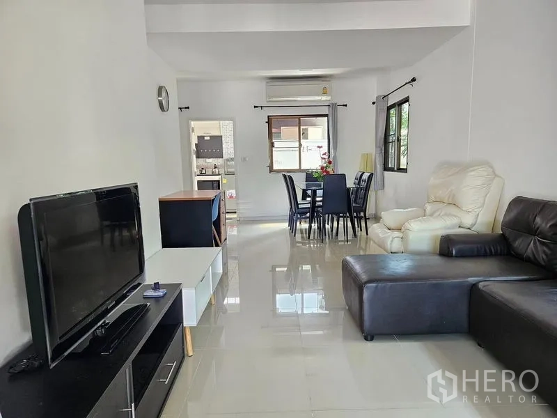 Townhouse for rent - Bright open-plan living and dining area with leather sofas, TV unit and glossy tiled floors.