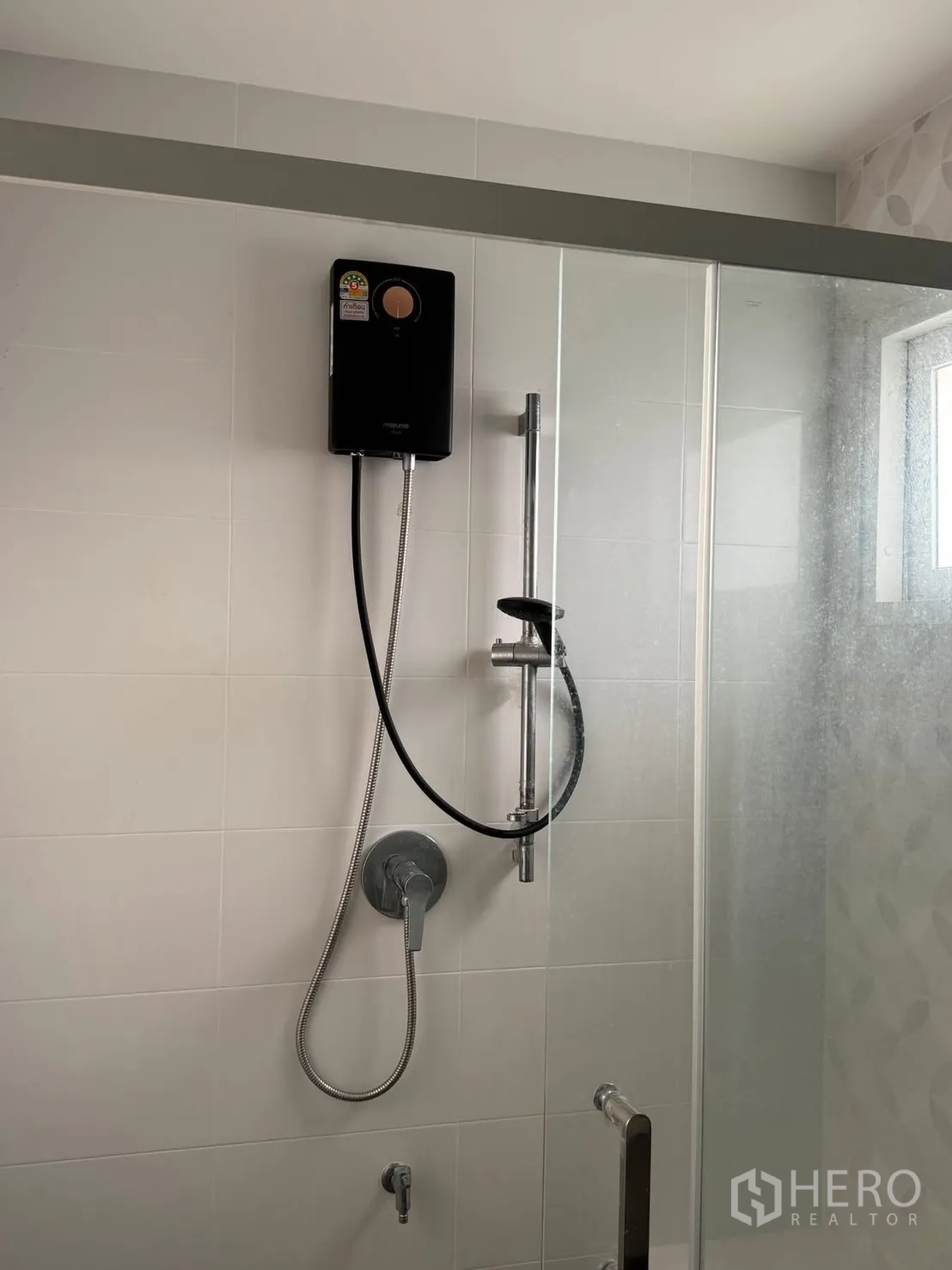 Detached House for rent in Bang Phli, Samut Prakan - Shower area with glass door, handheld shower, and water heater unit.