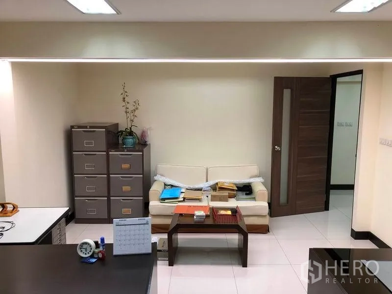 Home Office for rent in Khlong Toei, Bangkok - Manager’s office lounge with filing cabinets, small sofa and doorway to private room.