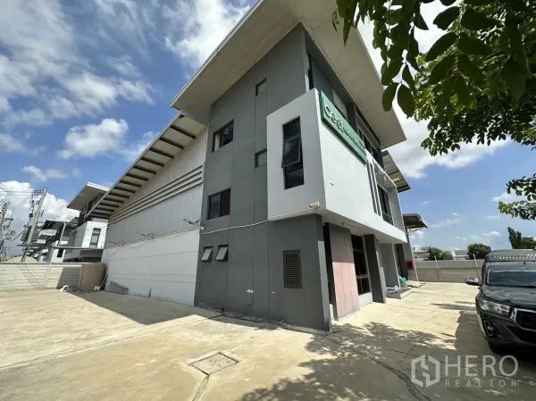 Factory for rent or sale in Pathum Thani - Corner exterior showing office block attached to high-roof factory building.