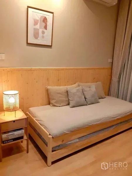 คอนโด ให้เช่าในRatchathewi, Bangkok - ห้องนอนเล็กอบอุ่น เตียงเดย์เบด ผนังไม้ และแสงไฟนุ่มนวล ในคอนโดโมเดิร์น