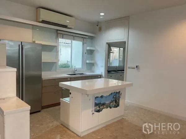 Detached House for rent or sale in Khan Na Yao, Bangkok - Bright modern kitchen with central island, built-in cabinetry and a double-door refrigerator.