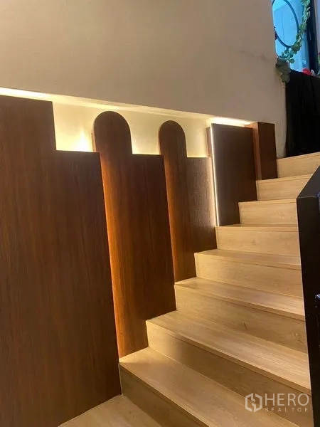 Shophouse for rent - Wood staircase with LED strip lighting and decorative wall panels.