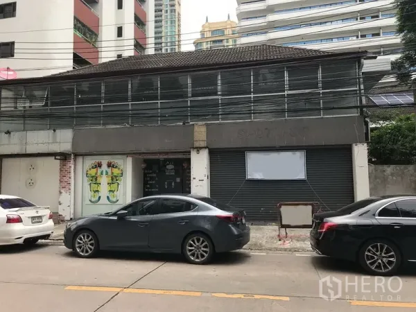 Retail Space for rent in Watthana, Bangkok - Two-storey shophouse-style retail frontage with roller shutters, glass entry and street parking in Sukhumvit.