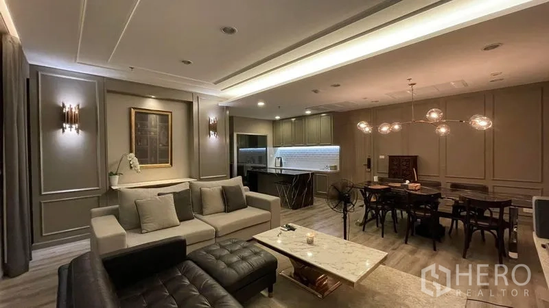 Condominium for sale in Sathon, Bangkok - Cozy living–dining space with sofa set, open kitchen, marble coffee table and cove lighting.