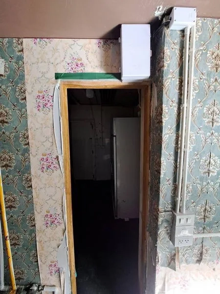 Retail Space for rent in Bang Rak, Bangkok - Doorway to rear storage or utility room with patterned wallpaper and exposed conduits.