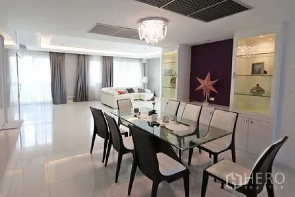 公寓 出租在Watthana, Bangkok - 现代餐厅，玻璃餐桌、六把椅子、水晶吊灯与内置展示柜。