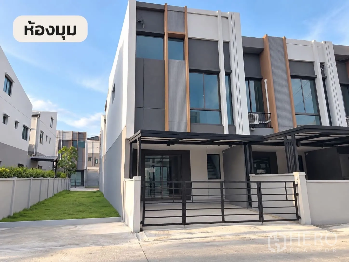 Townhouse for rent in Bang Phli, Samut Prakan - Modern corner townhouse exterior with gated carport and side lawn.