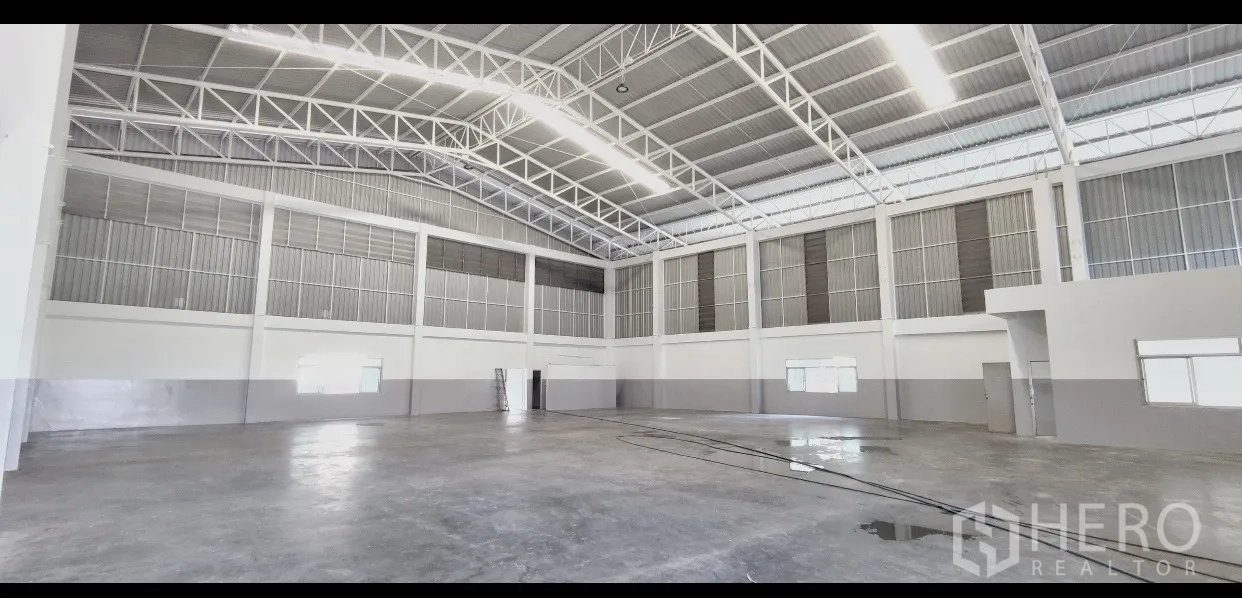 工厂 出租在Mueang Samut Prakan, Samut Prakan - 开阔生产区，抛光混凝土地面，高墙与通风百叶环绕。