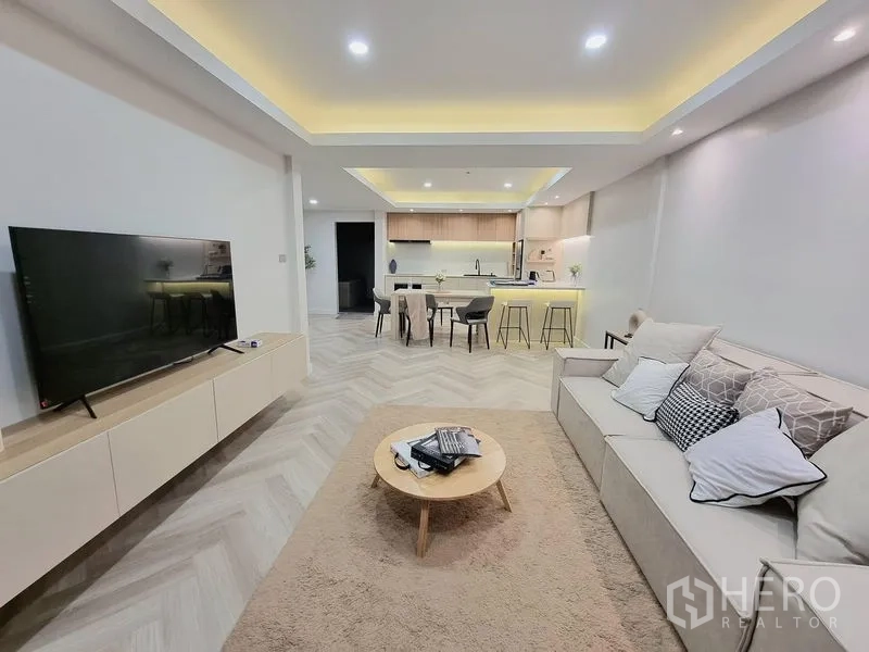 Townhouse for rent or sale - Open-plan living, dining and kitchen with TV wall, cove lighting and herringbone floors.