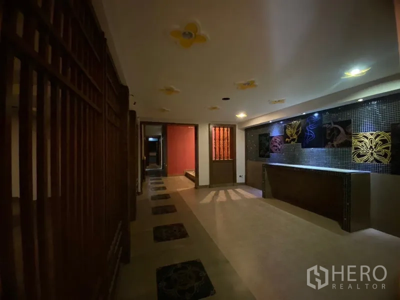 Retail Space for rent in Watthana, Bangkok - Ambient retail lobby with mosaic reception counter and decorative wall art.