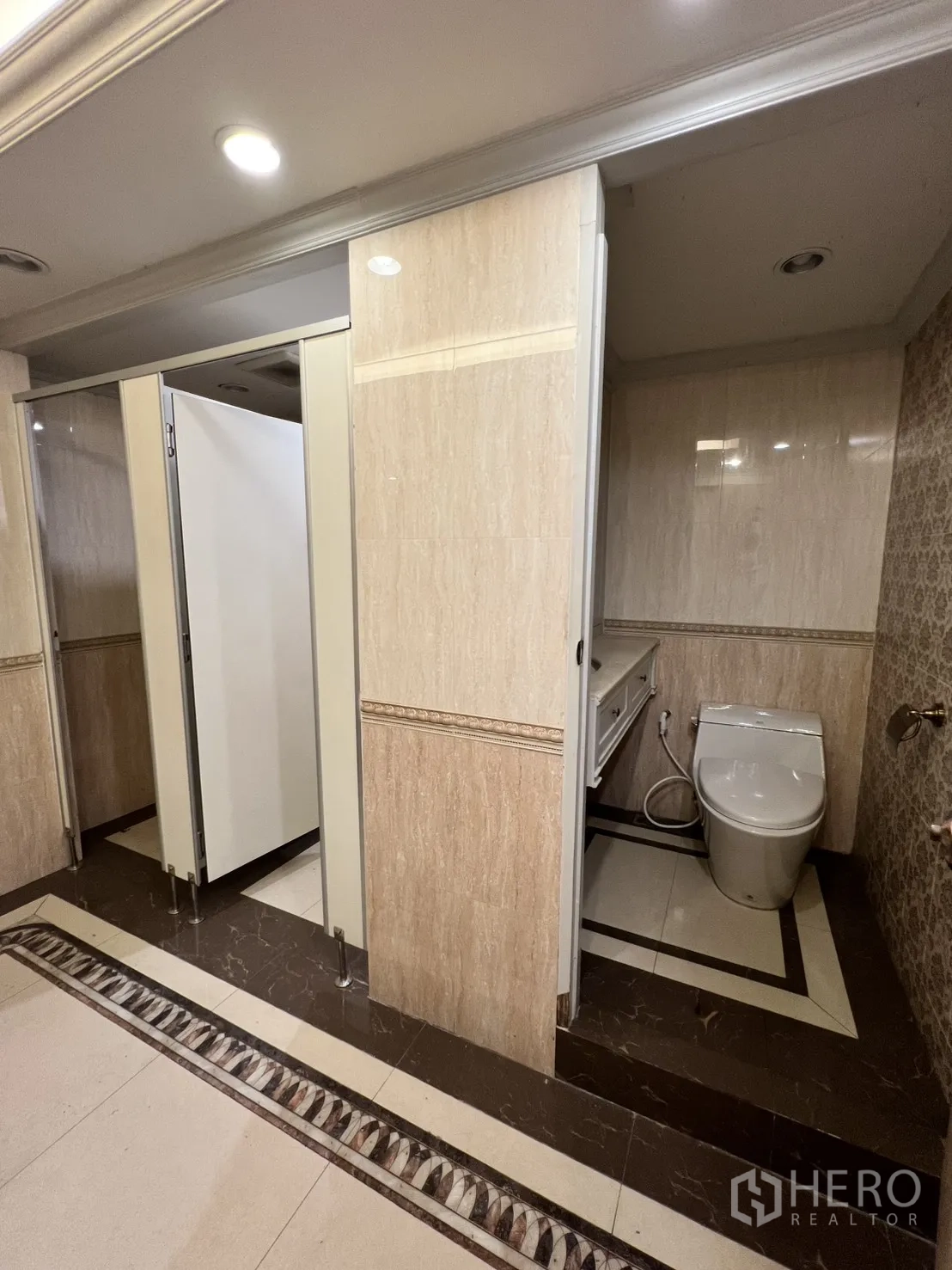 Office Space for rent in Watthana, Bangkok - Additional restroom with cubicles and modern toilet fixtures.