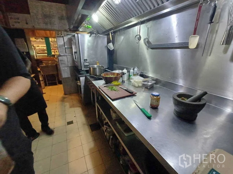 Retail Space for rent in Watthana, Bangkok - Kitchen prep line with utensils and ingredients on a stainless counter.