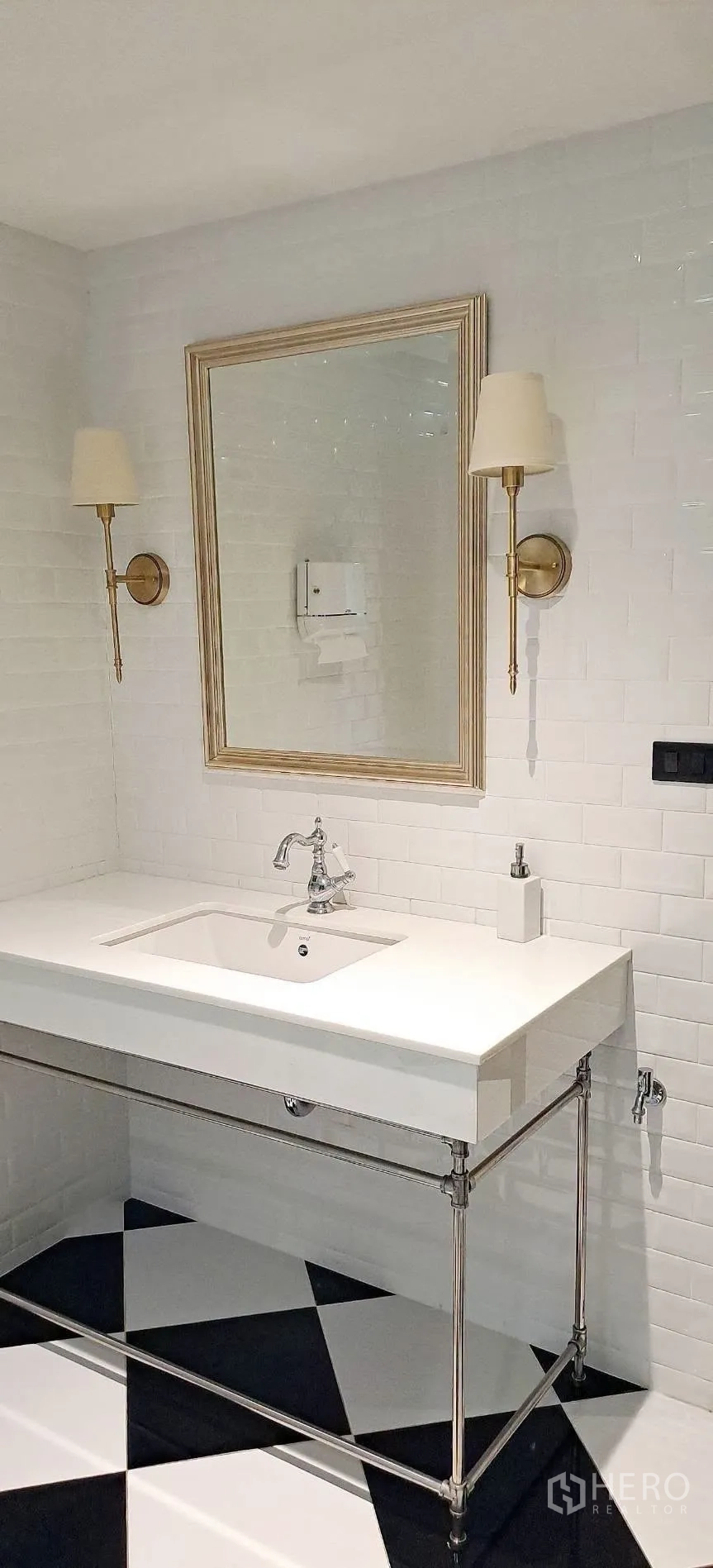 Home Office for rent in Lat Phrao, Bangkok - White tiled powder room with framed mirror and wall sconces.