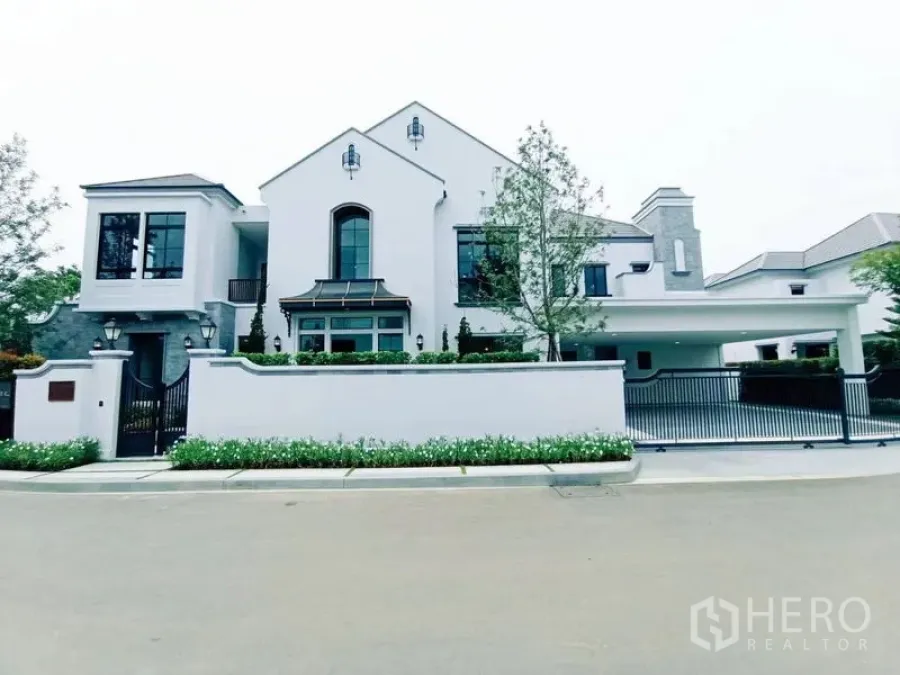 Detached House for sale in Saphan Sung, Bangkok - Contemporary white detached house with gated fence and covered carport.