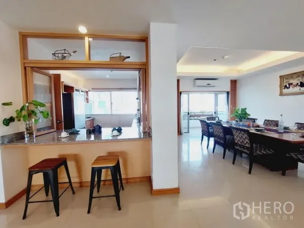 Apartment for rent - Breakfast bar opening to bright dining and living area with two stools.