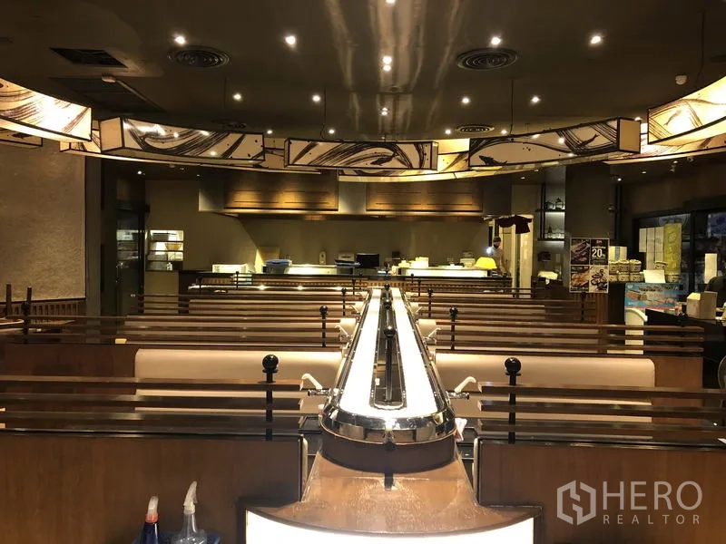 Retail Space for rent in Khlong Toei, Bangkok - Conveyor-belt sushi bar running through booths with an open kitchen at the rear.