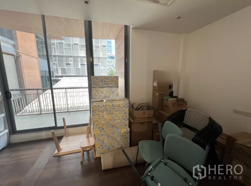 Retail Space for rent in Watthana, Bangkok - Secondary storage or office with large windows facing neighboring buildings.