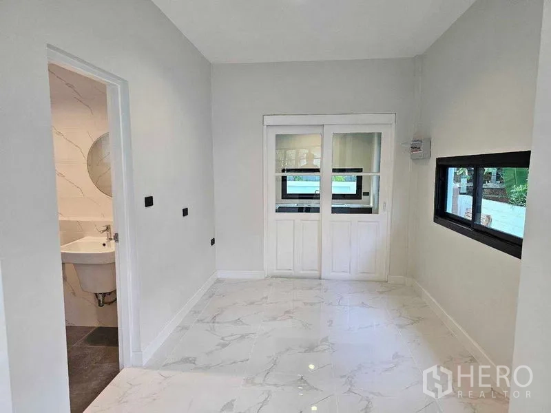 Detached House for sale in Thanyaburi, Pathum Thani - Ground-floor multipurpose room with sliding doors and adjoining bathroom.