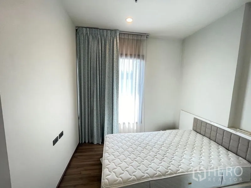 Condominium for rent in Khlong Toei, Bangkok - Open-plan dining and kitchen view with stainless fridge and bathroom access.