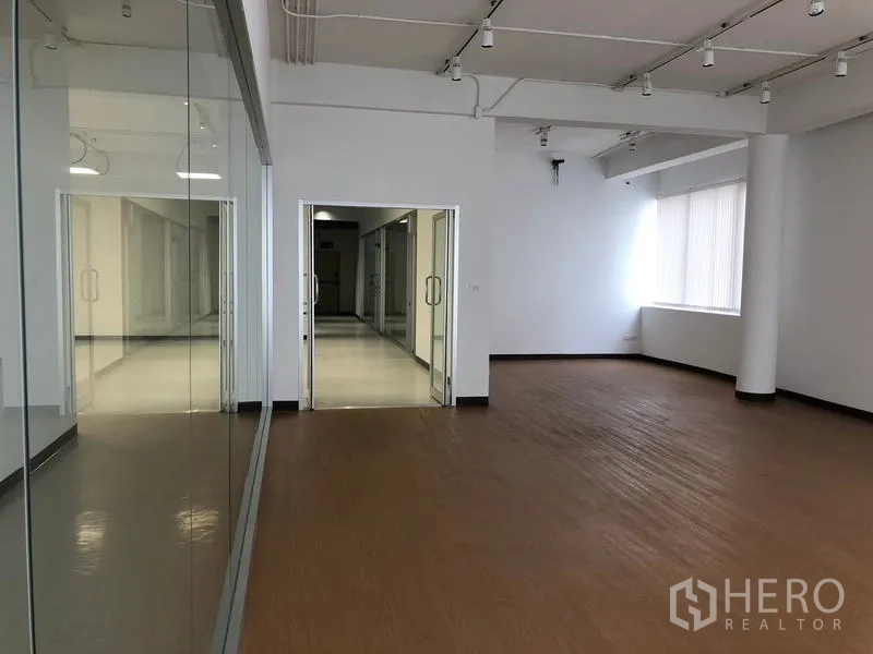 Office Space for rent in Bang Rak, Bangkok - Open office area with double glass doors, corridor view and natural light.