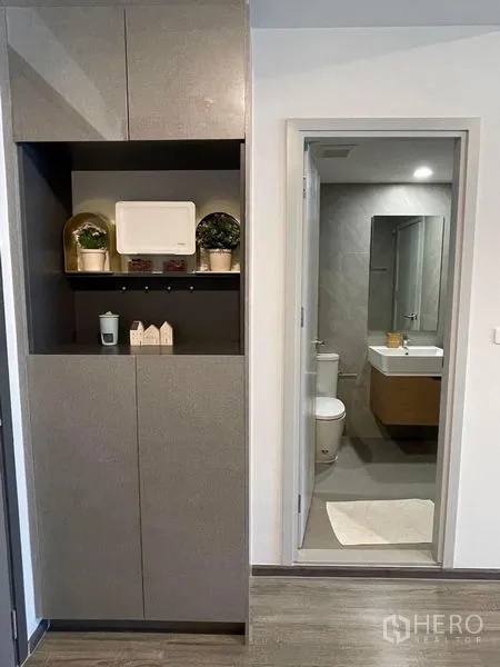Condominium for rent - Built-in storage cabinet in the entry hall leading to a tiled bathroom.