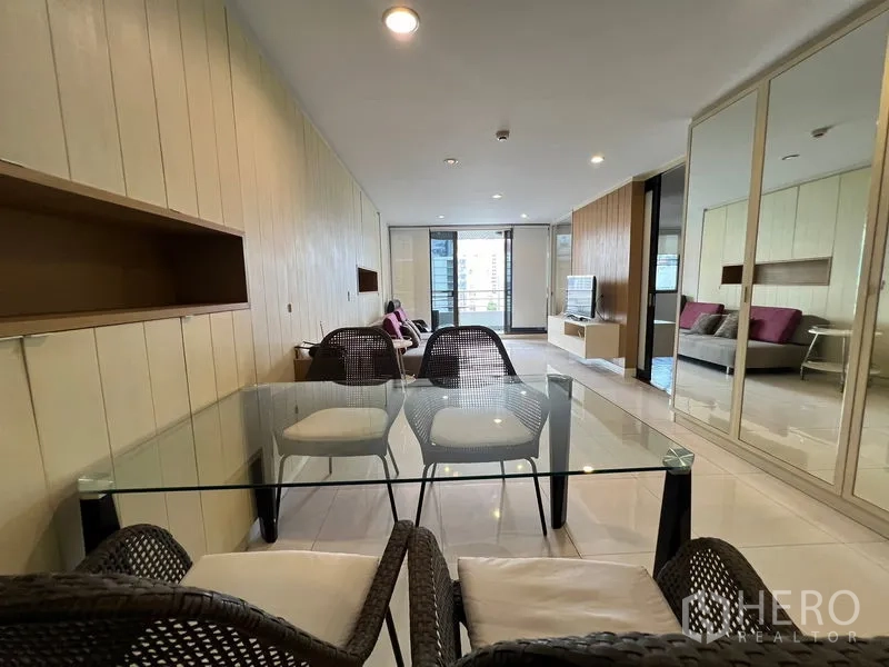 Condominium for rent or sale in Khlong Toei, Bangkok - Open-plan dining and living space leading to a balcony with city view.