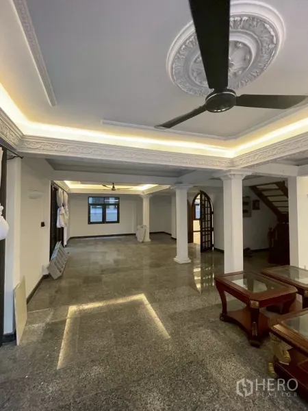 Detached House for rent in Watthana, Bangkok - Large living room with ornate ceiling moldings, recessed lighting and a ceiling fan.