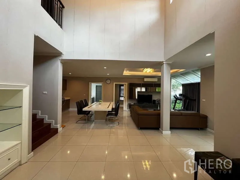 独立式住宅 出租在Prawet, Bangkok - 挑高客餐厅一体空间，瓷砖地面与立柱。