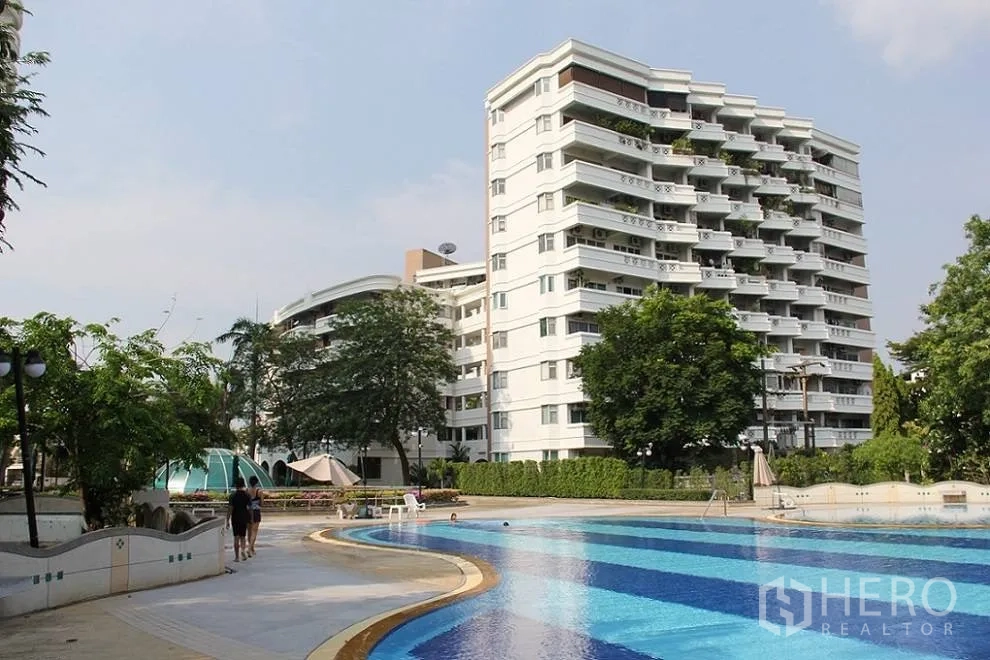 Condominium for sale in Wang Thonglang, Bangkok - Condominium exterior beside a resort-style swimming pool.