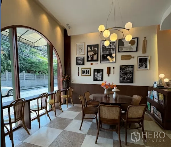 Retail Space for rent in Watthana, Bangkok - Bright lounge area by an arched window with chandelier and checkered floor.