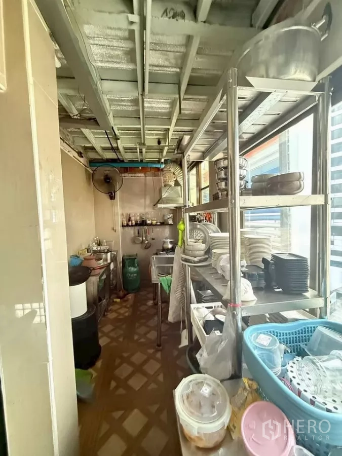 Retail Space for rent in Watthana, Bangkok - Narrow commercial kitchen with stainless shelves, cookware and window light.