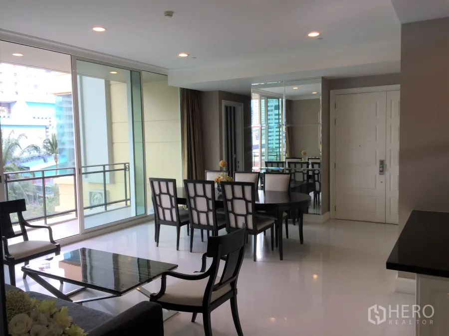 Condominium for rent in Watthana, Bangkok - Bright living and dining area with large sliding glass doors to a balcony and city views.