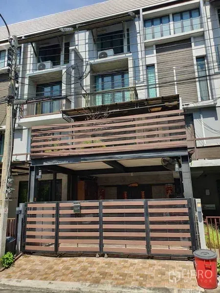 Townhouse for sale in Khlong Toei, Bangkok - Multi-storey townhouse facade with gated entrance and balconies.