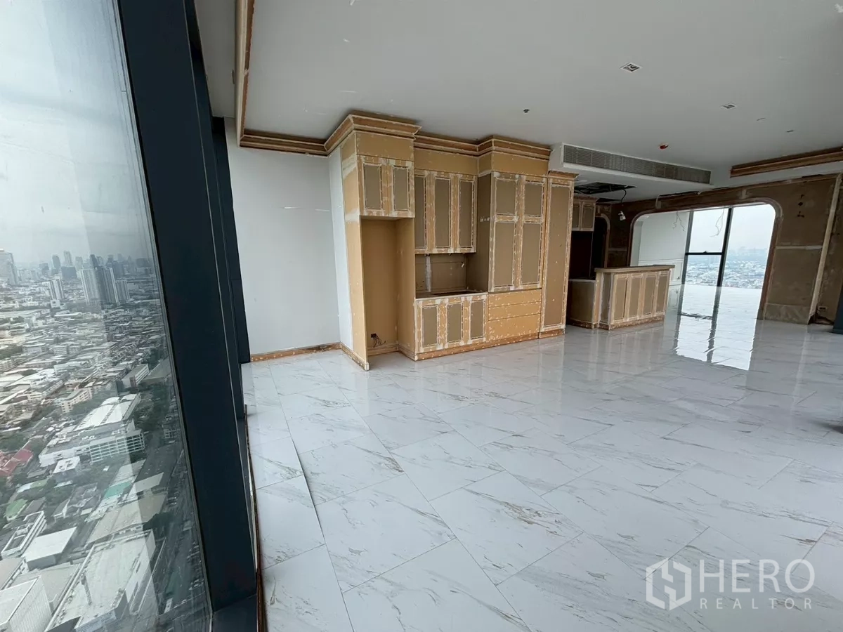 Condominium for sale in Bang Kho Laem, Bangkok - Bright dining space with panoramic glazing and custom millwork facing the city.