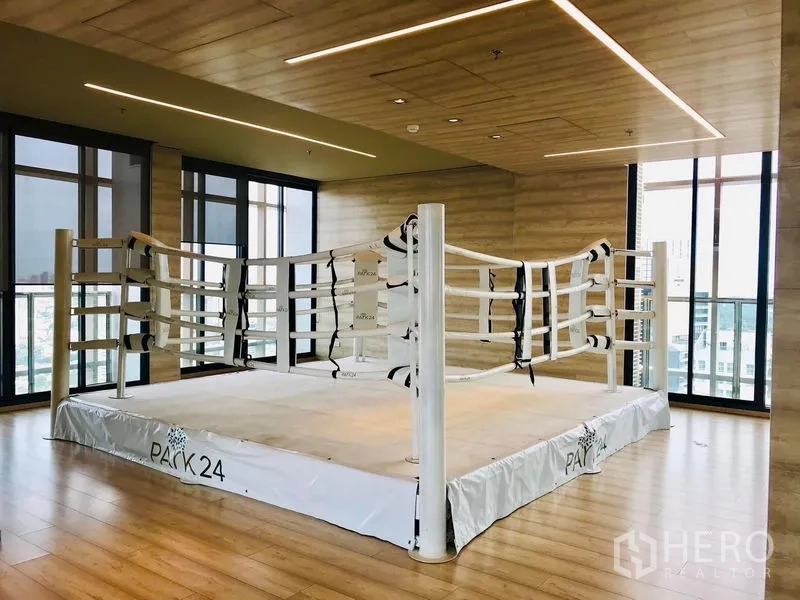 Condominium for rent in Khlong Toei, Bangkok - Indoor boxing ring in a studio with wood floors and city views.