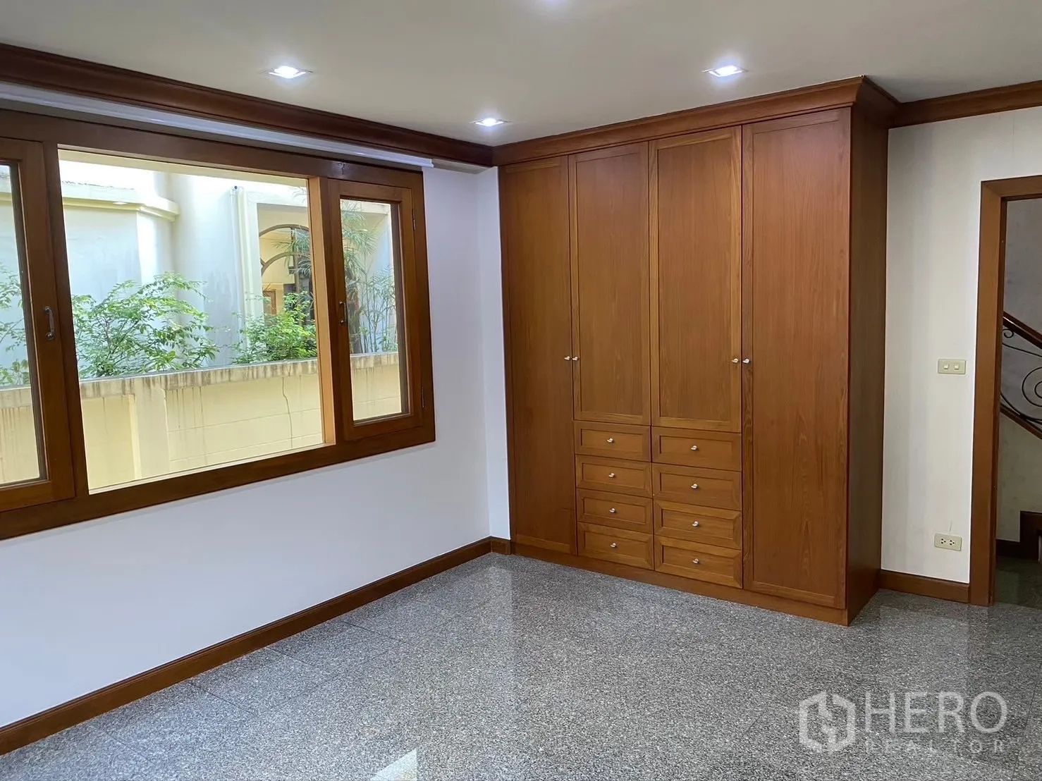 Detached House for rent in Watthana, Bangkok - Bedroom with tall wardrobes and large windows.