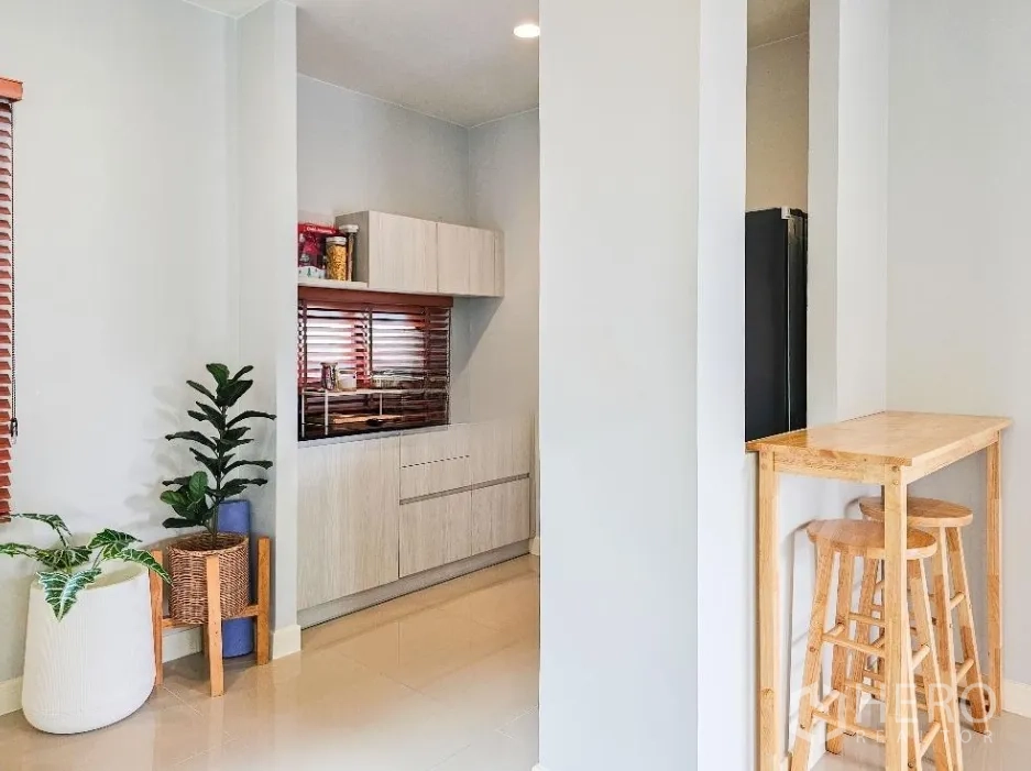 Detached House for sale in Lam Luk Ka, Pathum Thani - Pantry corner with storage cabinets, indoor plants and a breakfast bar with stools.
