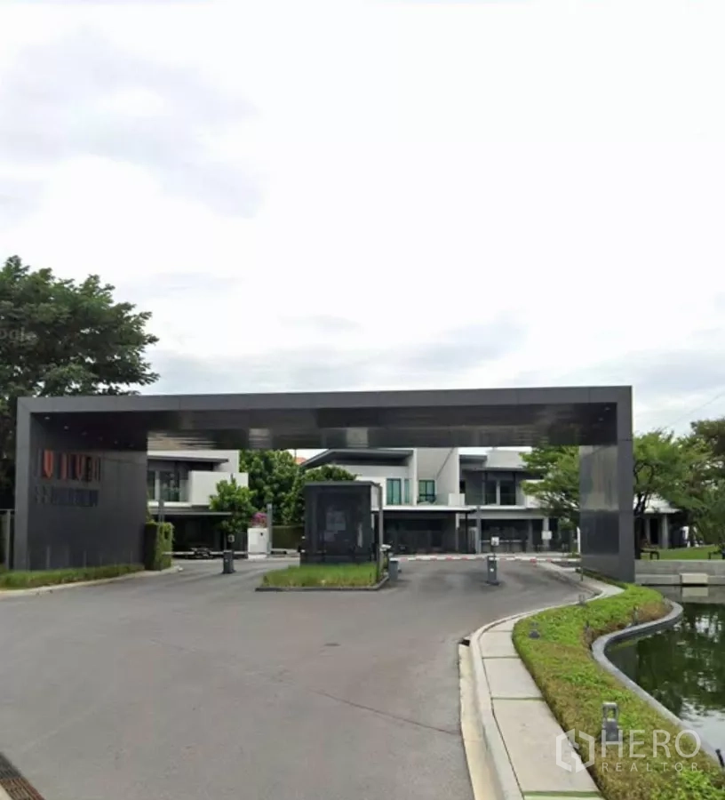 Detached House for rent in Bang Phli, Samut Prakan - Grand gated entrance of VIVE Bangna KM.7 with security barrier and landscaped water feature.