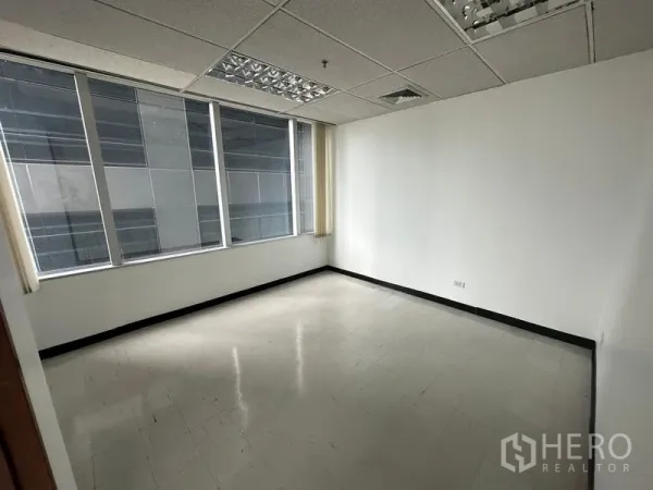 Office Space for rent in Chatuchak, Bangkok - Private office room with a large window facing a neighboring tower.