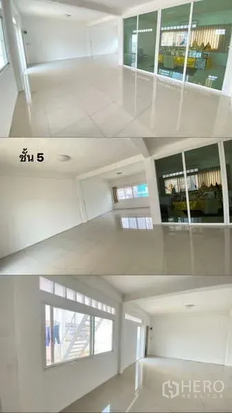 Shophouse for rent or sale in Watthana, Bangkok - Sunlit room on an upper floor with large windows and a full-length glass partition.