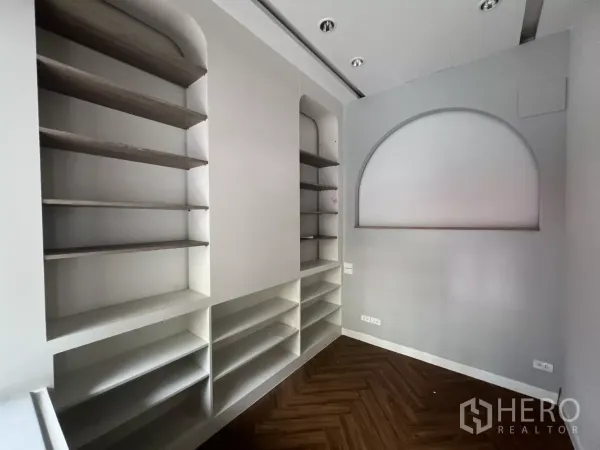 Retail Space for rent in Watthana, Bangkok - Close-up of custom wall shelves and an arched display niche in a small retail unit with downlights.