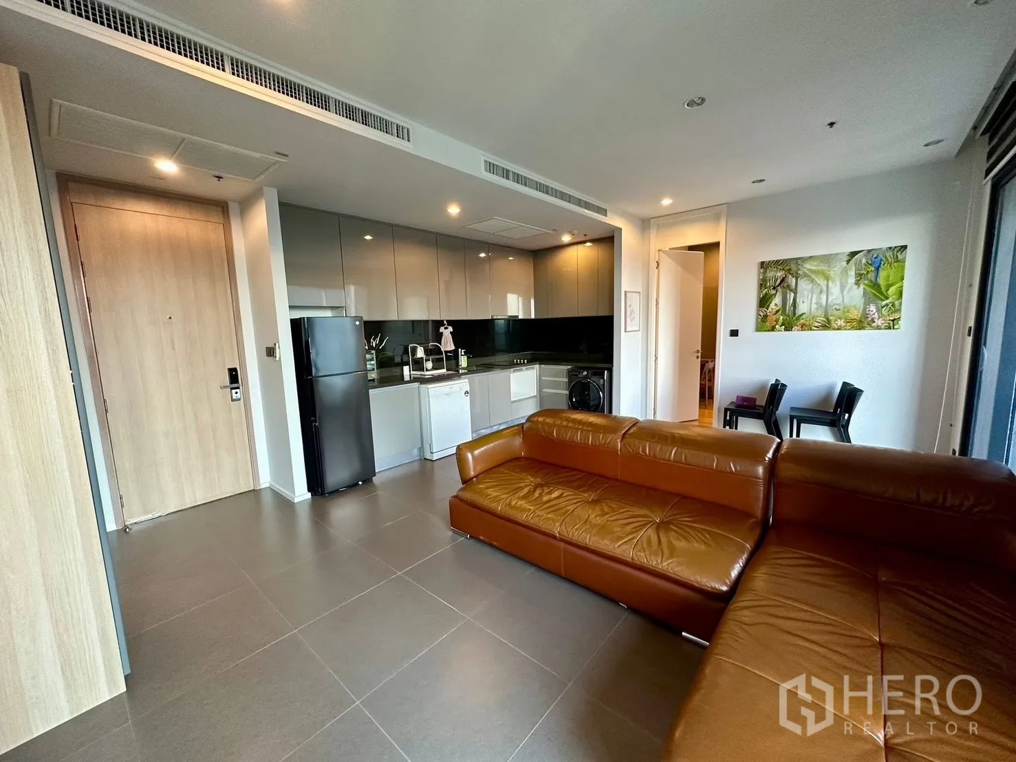 公寓 for rent or sale in Chatuchak, Bangkok - 开放式厨房与起居空间，带入户门与沙发。