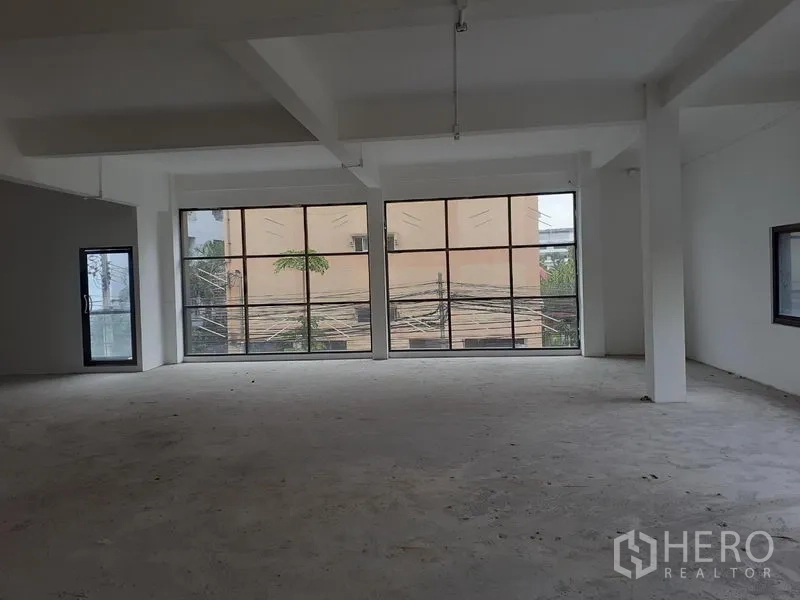办公空间 出租在Khlong Toei, Bangkok - 宽敞可二次装修的办公室，大面积玻璃、混凝土地面与侧窗。