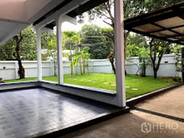 บ้าน ให้เช่าในSuan Luang, Bangkok - เฉลียงมีหลังคามองเห็นสนามหญ้าและต้นไม้ในสวนรั้วล้อม
