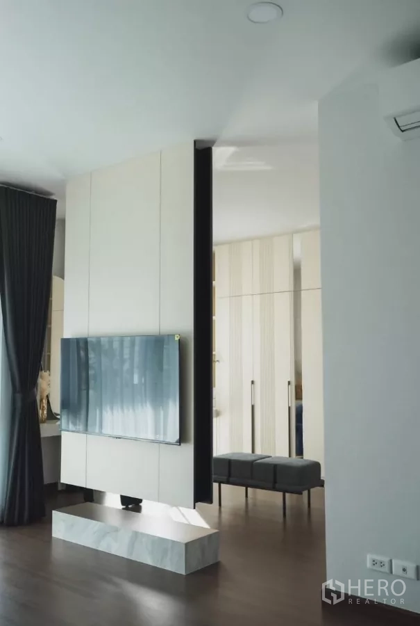 Detached House for rent in Bang Phli, Samut Prakan - Master suite with floating TV partition and dark wood flooring.