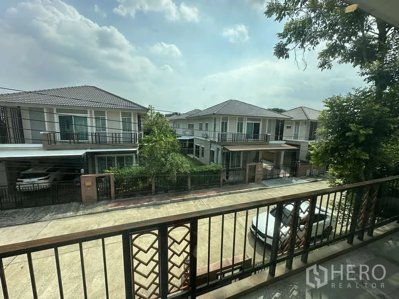 Detached House for sale in Sai Mai, Bangkok - Balcony view over tidy residential street and neighboring houses.