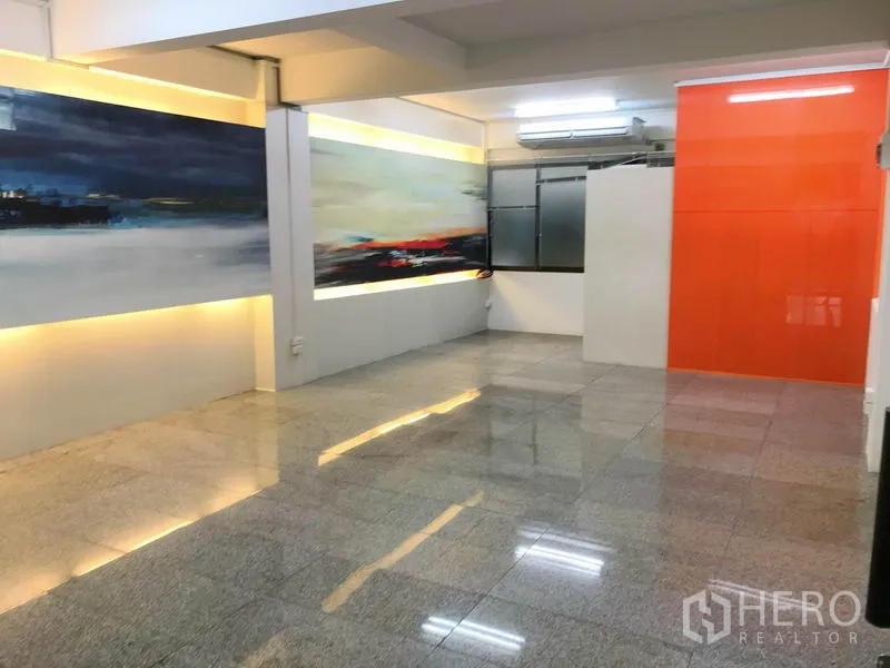 Office Space for rent in Suan Luang, Bangkok - Modern meeting or studio space with accent lighting and an orange feature wall.