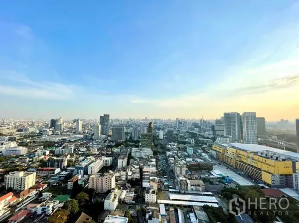 Condominium for rent in Chatuchak, Bangkok - High-floor view over the Chatuchak skyline with Central Ladprao mall at sunset.