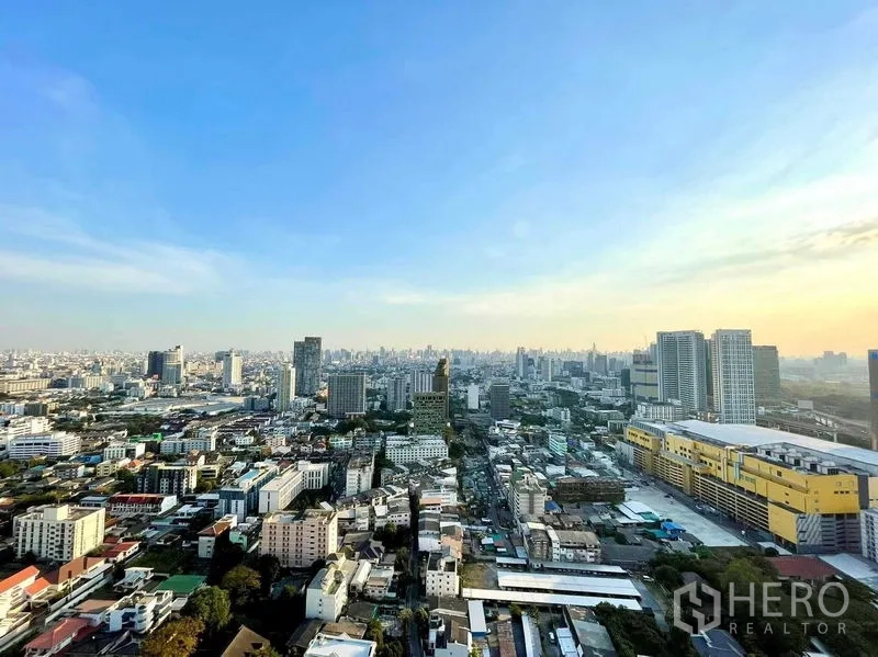 Condominium for rent in Chatuchak, Bangkok - High-floor view over the Chatuchak skyline with Central Ladprao mall at sunset.